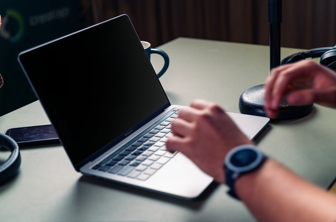 journalist typing on laptop