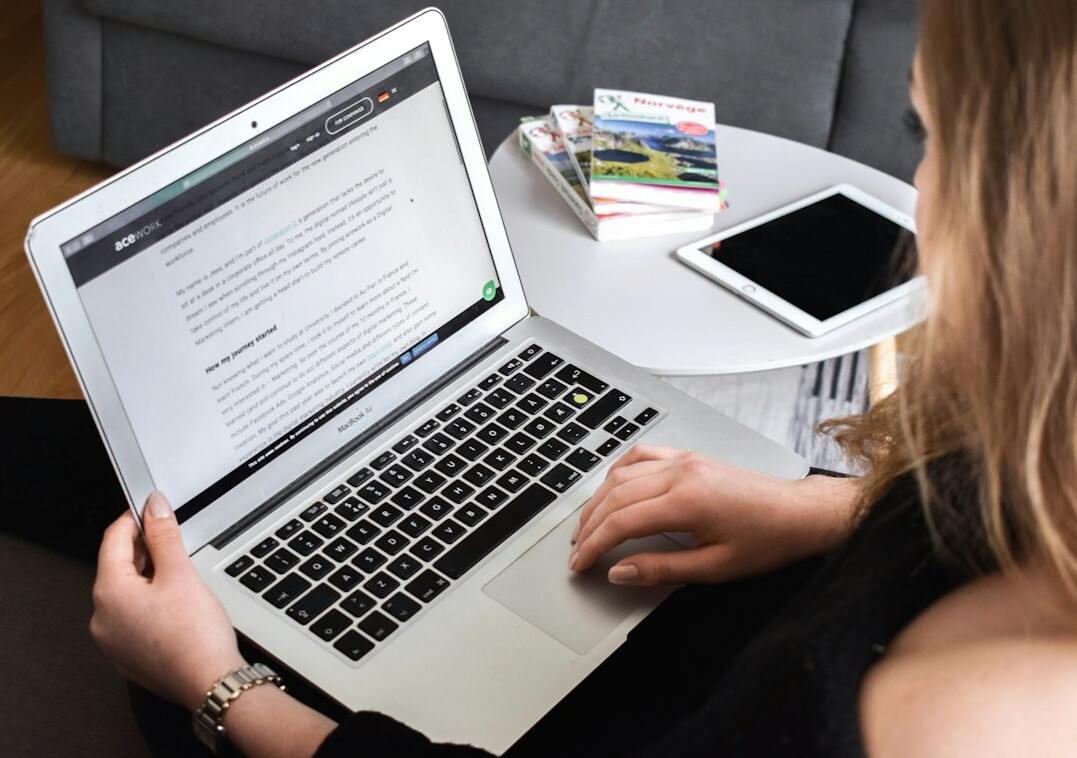 journalist typing on laptop